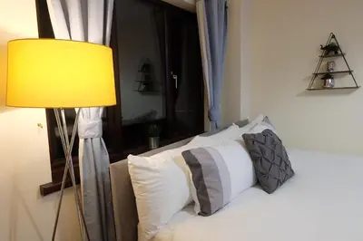 a bedroom with a bed with a yellow lamp at 15 Bronant in Talgarth