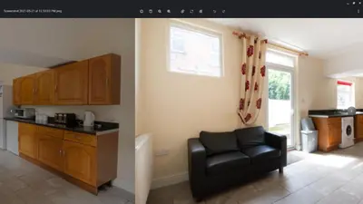 a kitchen with a black leather chair in a room at 52 Cambrian St in Aberystwyth
