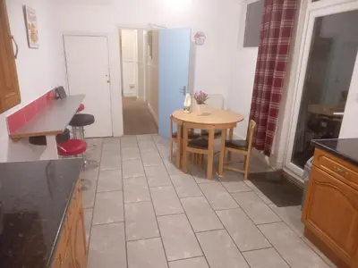 a kitchen with a table and a small table and chairs at 52 Cambrian St in Aberystwyth