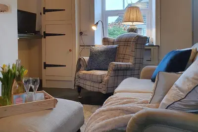 a living room with a couch and a chair at Llangollen 1-Bed Cottage Sleeps 2 with Parking in Llangollen