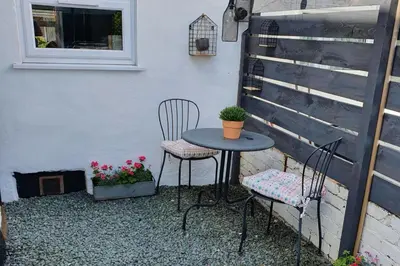 a small table and two chairs on a patio at Llangollen 1-Bed Cottage Sleeps 2 with Parking in Llangollen