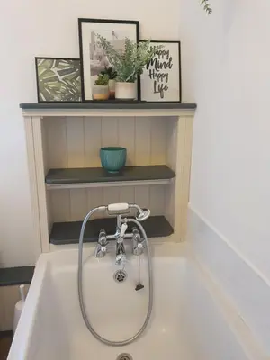 a bath tub with a shower in a bathroom at Llangollen 1-Bed Cottage Sleeps 2 with Parking in Llangollen