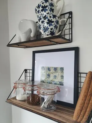 a mirror on a shelf with jars and vases at Llangollen 1-Bed Cottage Sleeps 2 with Parking in Llangollen