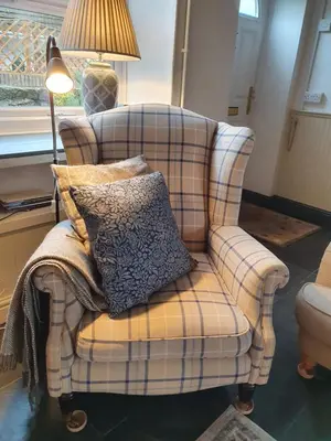 a chair with a pillow on it in a living room at Llangollen 1-Bed Cottage Sleeps 2 with Parking in Llangollen