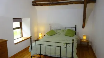 a bedroom with a bed with two green pillows at Blaentwrch Farmhouse in Llanddewi-Brefi