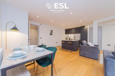a dining room and living room with a table and chairs at Modern 2 Bedroom Church Apartment 5 Mins to Town Centre - Free Parking in Shrewsbury