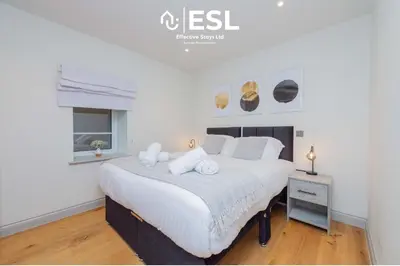 a bedroom with a large white bed in a room at Modern 2 Bedroom Church Apartment 5 Mins to Town Centre - Free Parking in Shrewsbury
