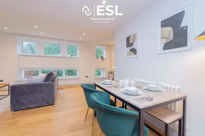 a dining room and living room with a table and chairs at Modern 2 Bedroom Church Apartment 5 Mins to Town Centre - Free Parking in Shrewsbury