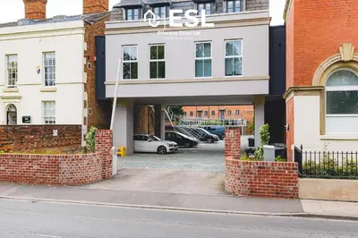 a building with a parking lot in front of it at Modern 2 Bedroom Church Apartment 5 Mins to Town Centre - Free Parking in Shrewsbury