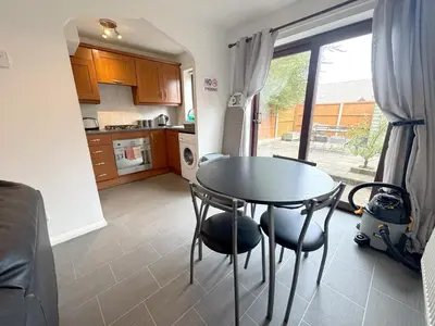 a kitchen with a table and chairs in a room at 2 bed house, walking distance Shrewsbury centre in Shrewsbury