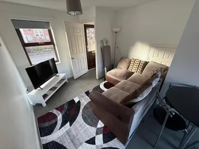 a living room with a couch and a tv at 2 bed house, walking distance Shrewsbury centre in Shrewsbury
