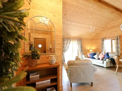 a living room with a couch and a chair at The Larches in Llanidloes