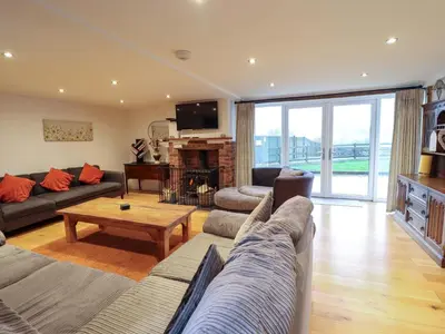 a living room with a couch and a table at Bwthyn Y Bugail Shepherd's Cottage in Oswestry