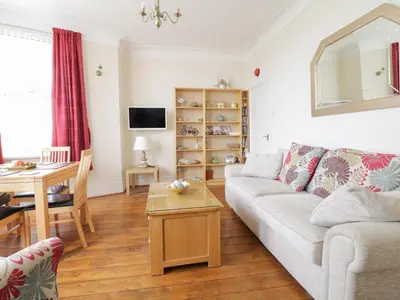 a living room with a couch and a table at The Nook in Tywyn