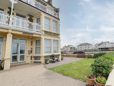 an exterior view of a house with a patio at The Nook in Tywyn
