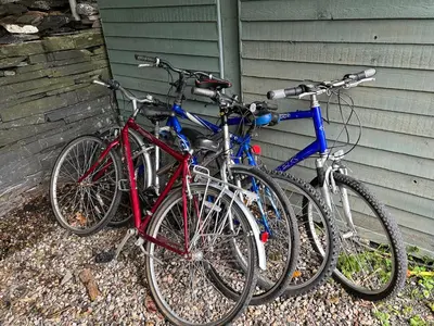 three bikes are parked next to a house at Milkwood Cottage in Corwen
