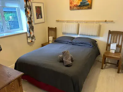 a bedroom with a bed with two pillows on it at Milkwood Cottage in Corwen