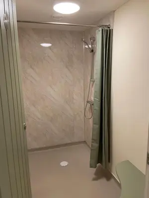 a bathroom with a shower with a shower curtain at Panpwnton Farm Bell Tents in Knighton