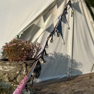 a planter with flowers in it next to a building at Panpwnton Farm Bell Tents in Knighton