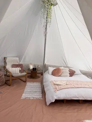 a bedroom with two beds and a tent at Panpwnton Farm Bell Tents in Knighton