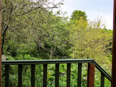 a balcony with a view of the woods at Milford Tree Tops in Craven Arms