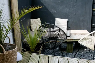 a patio with a table and chairs and plants at Fern Studio 1 Bedroom Apartment in Llangollen