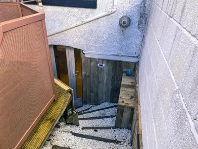 an alley with a door and a stairway leading into a building at Fern Studio 1 Bedroom Apartment in Llangollen