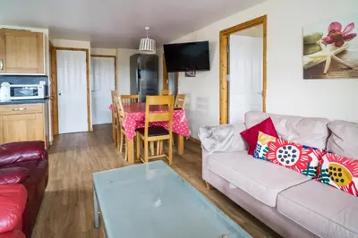 a living room with a couch and a table at The Pine Lodge in Aberystwyth