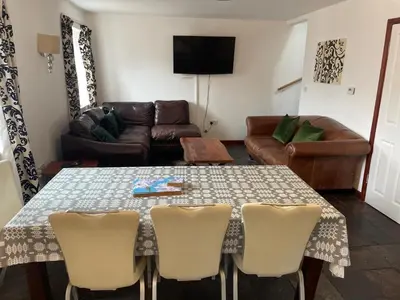 a living room with a table and a couch at The Stable in Aberystwyth