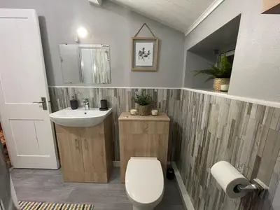 a bathroom with a white toilet and a sink at Westend Holiday Room 4 Brecon in Brecon