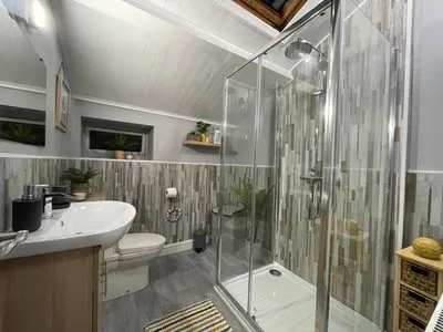 a bathroom with a shower and a toilet and a sink at Westend Holiday Room 4 Brecon in Brecon