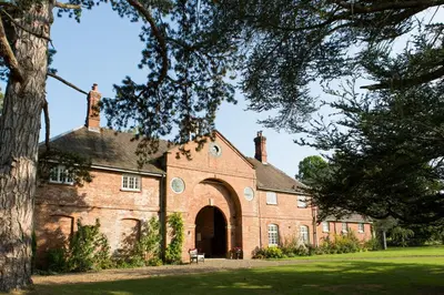 an old red brick building with a large doorway at Henley Hall, Ludlow in Ludlow