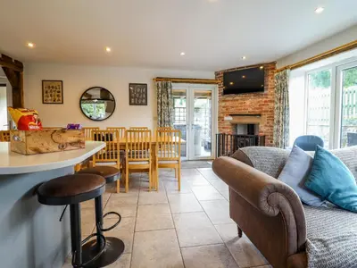 a living room with a couch and a table at Y Stabl The Stable in Oswestry