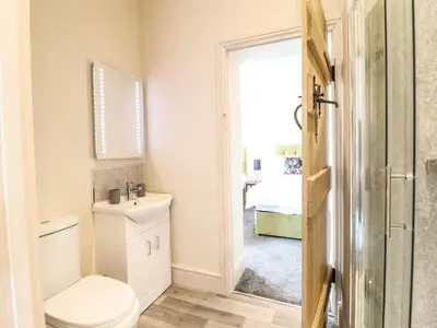 a bathroom with a toilet and a sink at Bodaioch Hall in Caersws