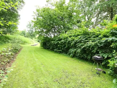 a grill sitting in the grass next to a path at Pant Y Rhedyn in Llandrindod Wells