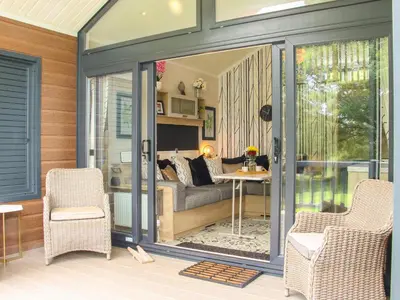 a screened in porch with a couch and a table at Jacob's Meadow Pod 2 in Shrewsbury
