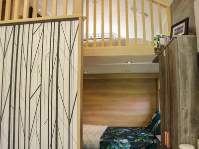 a small room with a bunk bed and a staircase at Jacob's Meadow Pod 2 in Shrewsbury