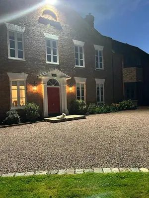 a large brick house with a dog sitting in front of it at Winsley Park Farm in Leominster