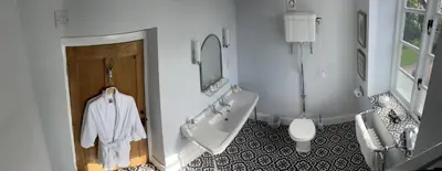 a bathroom with a tub and a sink and a toilet at Winsley Park Farm in Leominster