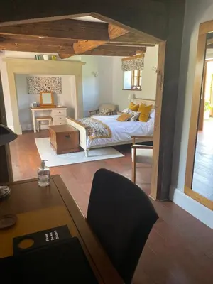a large bedroom with a bed and a desk at Winsley Park Farm in Leominster