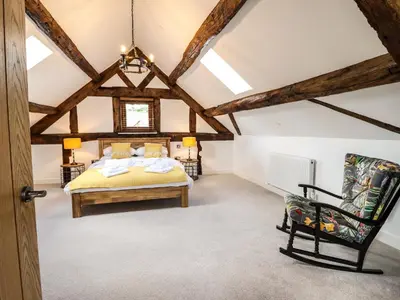 a bedroom with a bed and a chair at Swallows Rest in Montgomery