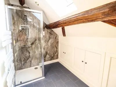 a bathroom with a glass shower in a attic at Swallows Rest in Montgomery