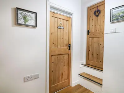 a hallway with a wooden door in a house at The Toll House in Dolgellau