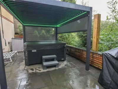 a pergola with a bench in a patio at Sunnyside in Leominster