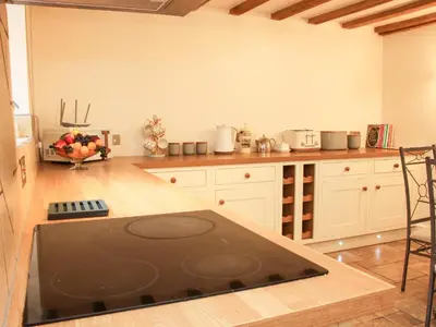 a kitchen with a black counter top in a room at Linley Lane Cottage in Bishops Castle