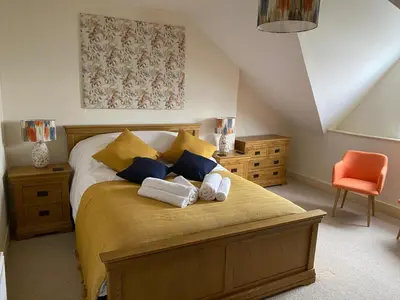 a bedroom with a bed with two towels on it at No6 in Barmouth