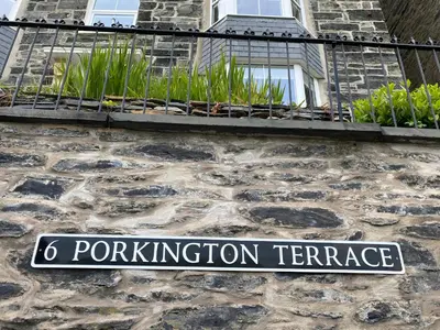 a street sign on the side of a building at No6 in Barmouth