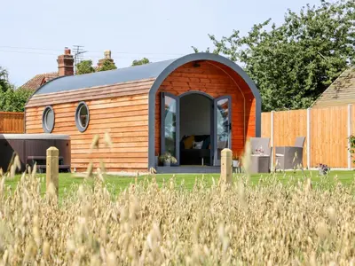 a tiny house is shown in a yard at Withy Willows in Craven Arms