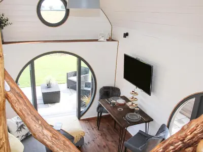 a living room with a tv and a table at Cherry Blossom in Craven Arms