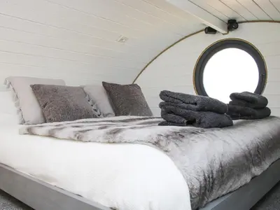 a bedroom with a bed with a mirror on it at Cherry Blossom in Craven Arms